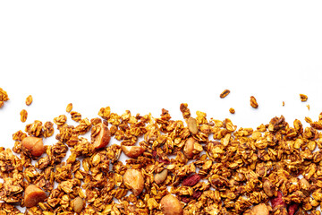 Granola texture on a white background, with copy space. Organic gourmet muesli, overhead flat lay shot. Oat flakes, honey, nuts, and berries