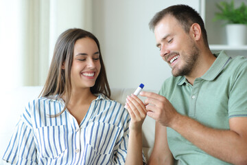 Couple vaping and sharing vaper at home