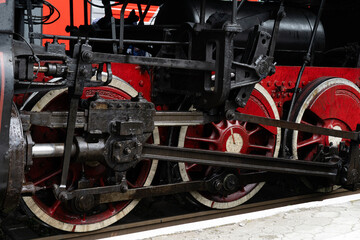Fototapeta premium Vintage steam locomotive wheels and machinery showcase unique engineering at historic railway station