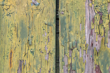 Old wood with cracked yellow green paint