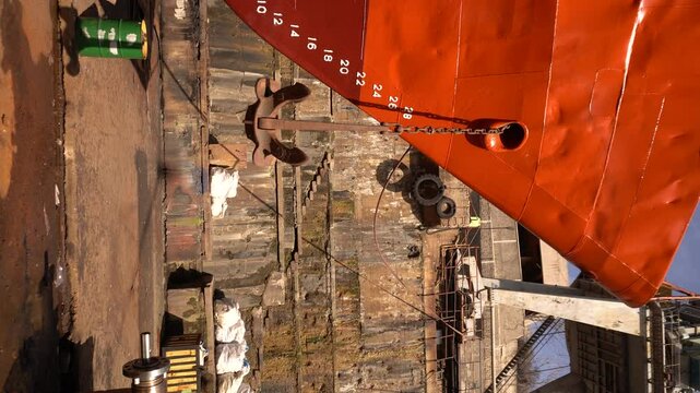 Anchor of ship. Heaving up anchor in dry dock. Vessel ashore on ship repairing yard. Anchor Installation.