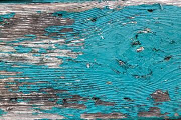 Old weathered wood with peeling turquoise paint