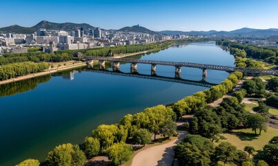 Fototapeta premium Panoramic view of a river and bridge over city. Scenic urban landscape with tranquil river reflecting skyline. Possible use for travel or urban planning publications