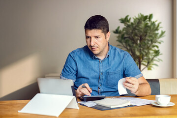 Stressed owner checking bills, tax deduction due to world tariffs - Businessman calculating business balance prepare tax fees
