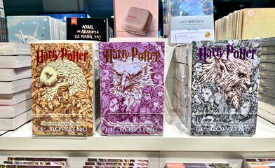 Fototapeta premium Jakarta, Indonesia - April 28th, 2025 - Harry Potter novel books isolated on horizontal indoor Gramedia book store shelf environment background.