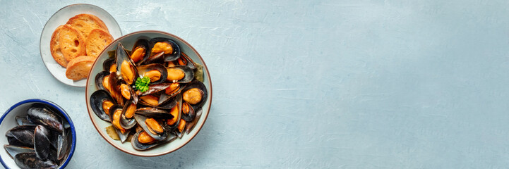 Mussels with toasted bread panorama, overhead flat lay shot of moules frites, panoramic banner