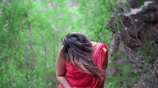 Happy Indian Woman In Red Sari Smiling At The Camera. - wide shot