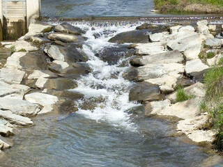 Rocky stream waterfall flowing over stones in nature