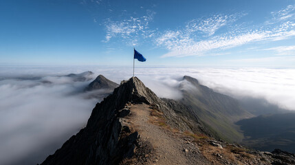 Blue flag atop mountain peak above cloudscape, representing achievement, success, and exploration of heights