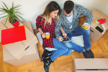 Young couple moving in to a new apartment. Shallow DOF. Developed from RAW; retouched with special...