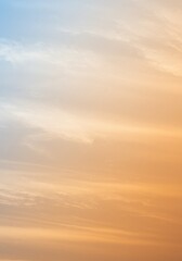 Fototapeta premium A serene orange and blue gradient sky with soft clouds evokes tranquility and harmony.