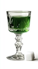 Elegant Green Absinthe Drink Served in Vintage Crystal Glass Alongside Sugar Cube on White Background