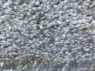 Granite stone texture close-up with rough gray surface detail