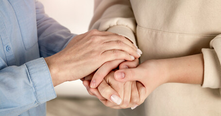 Supportive female hands - young and mature woman grasping hands in gesture of help, compassion,...
