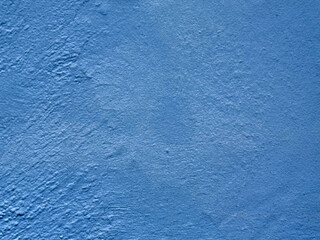 Textured blue wall surface with rough pattern background