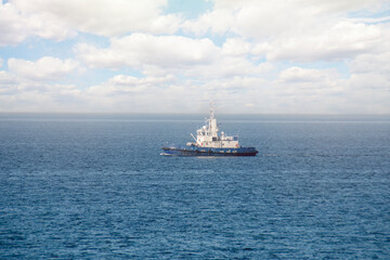 A small tugboat sails across the sea.