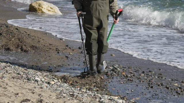 Beach MetalDetector Treasure Sunny day man searches seashore sand pebbles waves for lost items hobby