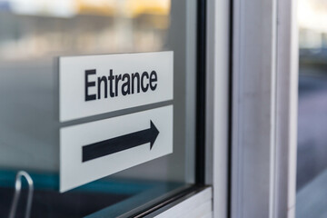 Entrance sign with black arrow