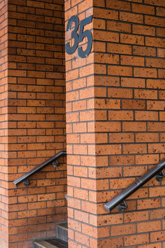 Number 35 on brick walls with handrails and steps