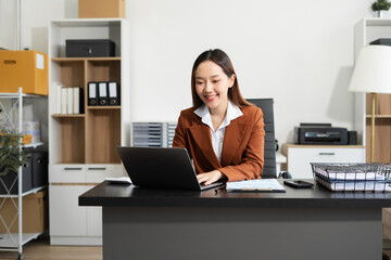 Businesswomen work on laptop on the table at the office with information documents.