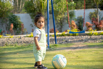 Little kid playing in garden area or park	