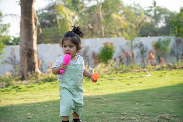 Little kid playing in garden area or park