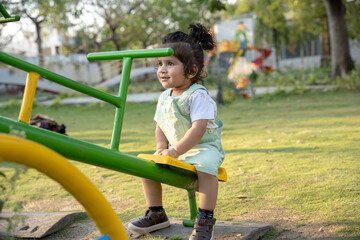 Little kid playing in garden area or park