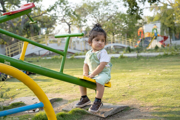 Little kid playing in garden area or park