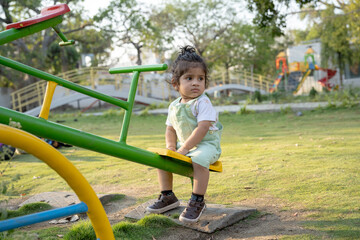 Little kid playing in garden area or park