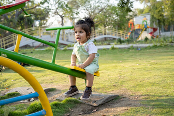 Little kid playing in garden area or park