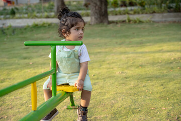Little kid playing in garden area or park