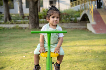 Little kid playing in garden area or park