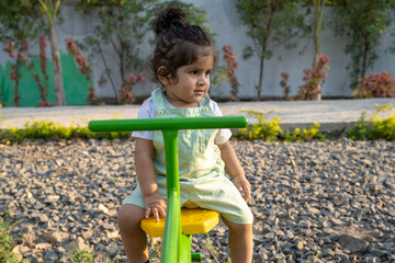 Little kid playing in garden area or park