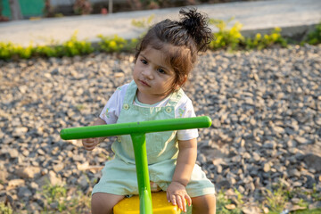 Little kid playing in garden area or park