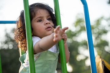 Little kid playing in garden area or park
