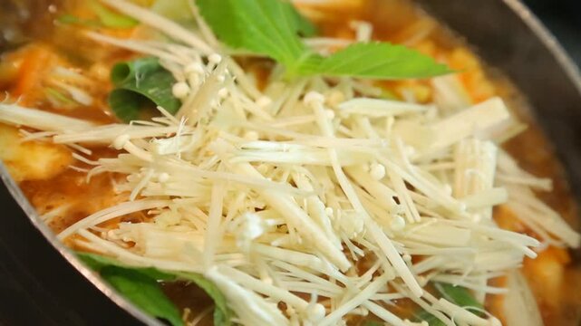 Spicy floating goby stew with enoki mushrooms