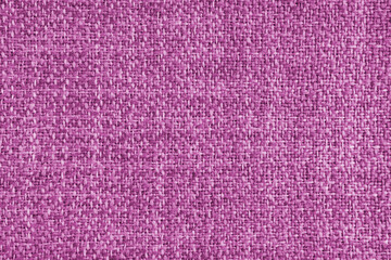 Upholstery pink colored jacquard fabric coarse weave texture. Textile background, furniture textile material, wallpaper, backdrop. Cloth structure close up, macro