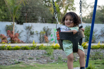 Little kid playing in garden area or park