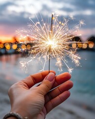Patriotic celebration moments A hand holding a sparkler against a stunning sunset, capturing the festive mood of celebrations and joyful moments at the beach.