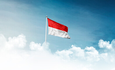 Indonesia national flag with mast waving in beautiful sky. Indonesia flag for Republic Day and...