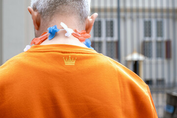 man back orange sweater garland Dutch flag birthday King Netherlands
