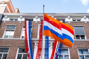 Flag Netherlands blue sky old city Holland building Den Haag Koningsdag orange