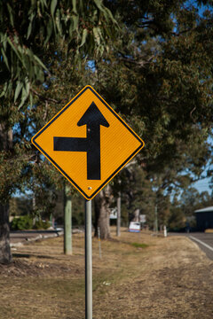 Side road ahead to the left road sign