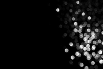 White gray blurred bokeh lights on black background. Glitter sparkle stars for celebrate. Overlay for your design