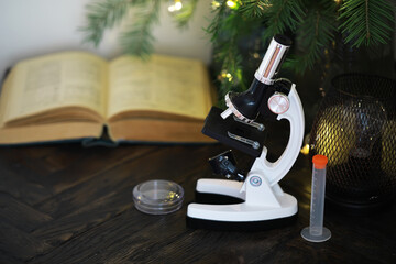 Christmas Research: Microscope with Open Book, Test Tube, Petri Dish, and Festive Tree