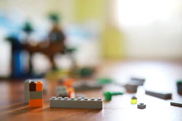 Colorful Bricks Scattered on Wooden Floor in Bright Room