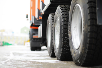 Close-Up of Truck Tires on a Snow-Covered Road Highlighting Winter Transportation © alexkich