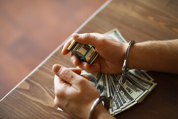 Handcuffed Person Holding Money - Concept of Financial Crime and Corruption