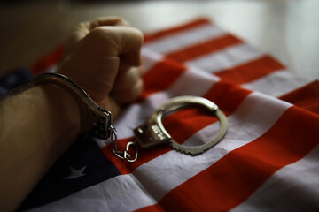 Handcuffed Fist on American Flag Depicting Legal Struggles and Patriotism