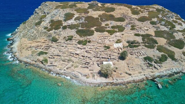 High angle perspective Mochlos Minoan ruins on Crete with clear Aegean sea